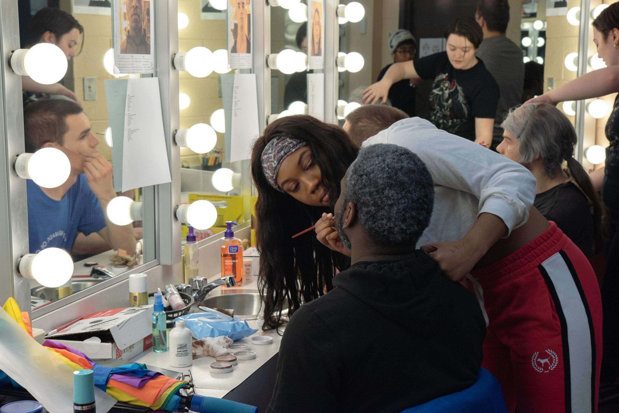 Theatre student applying makeup at Berea College