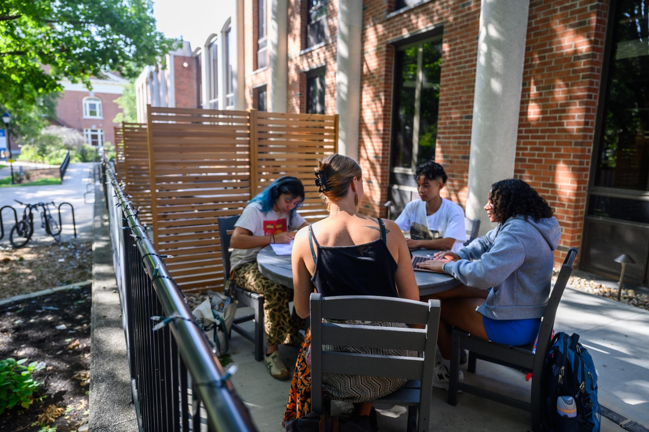Berea College students sit outside the library